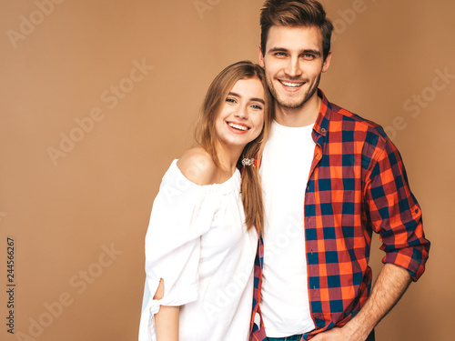 Smiling Beautiful Girl and her Handsome Boyfriend laughing.Happy Cheerful Family.Valentine's Day. Posing on beige wall. Hugging © halayalex