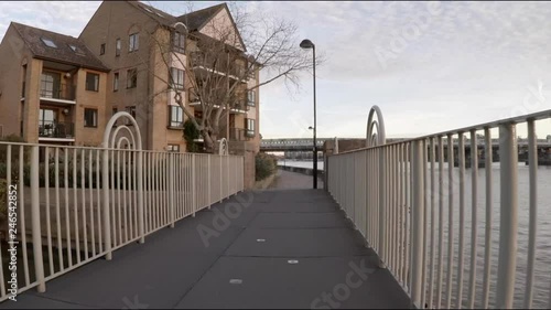 walking on a bridge next to river Thames in london UK © blackboxguild