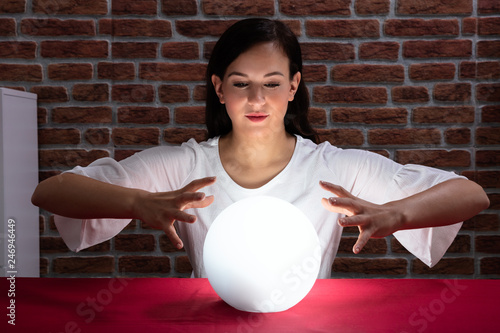 Woman Predicting Future With Crystal Ball © Andrey Popov