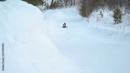 Girl and Woman Riding Fast on a Snow Tubing © Kmikhidov
