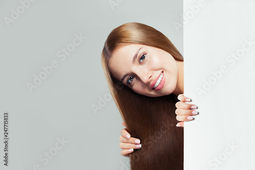 Happy woman with white empty paper board background with copy space for advertising marketing or product placement © artmim
