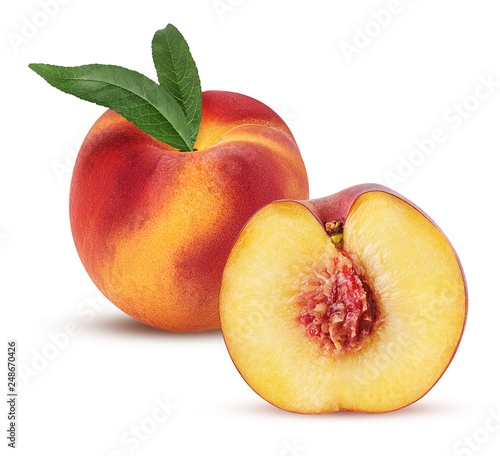 Ripe peach fruit and one cut in half with bone and leaf © Olha