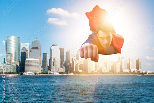 Superhero businessman flying over the city