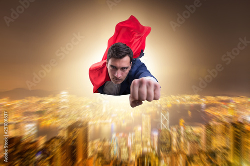 Superhero businessman flying over the city