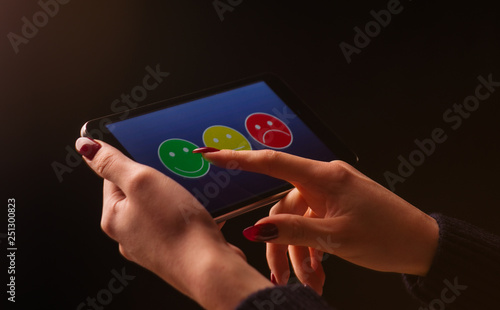 Woman Using Tablet To Give Review Opinion And Feedback To Survey - woman using tablet to give review opinion and feedback to survey