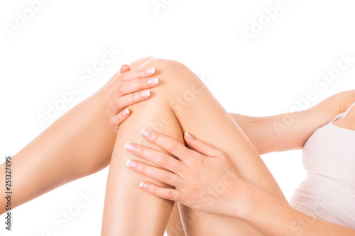 Well-groomed female legs after depilation isolated on white background. Skin care and hair removing concept © Stavros