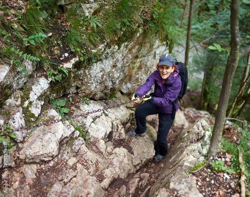 Woman climbing a difficult trail