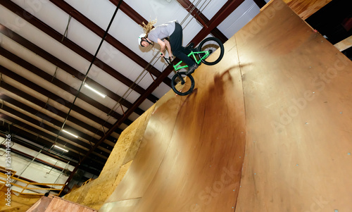 Man jumping and riding on a BMX bicycle at an extreme sports park © Tierney