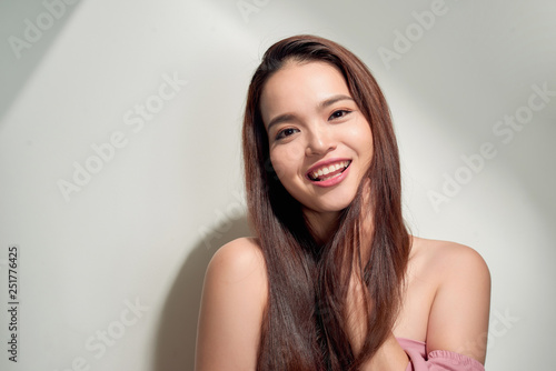 Young smiling woman outdoors portrait. Soft sunny colors.Close portrait. beautiful smiling girl. Woman in the city in summertime. Summer outdoor portrait © makistock