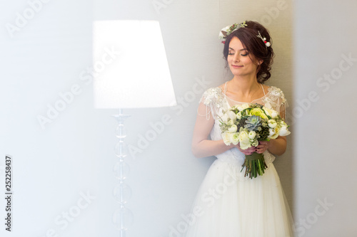 Beautiful model in wedding dress posing in hotel room © hreniuca