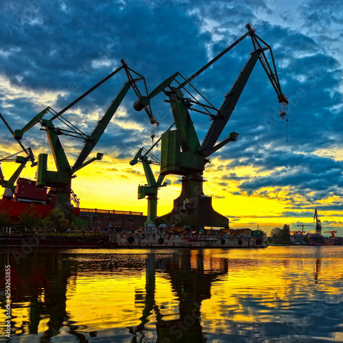 Big shipyard cranes at sunset in Gdansk, Poland. © Nightman1965