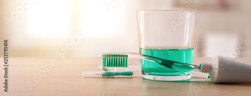 Equipment for oral hygiene on wood table in bathroom panoramic © Davizro Photography