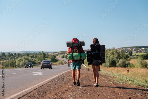 Travel man hitchhiking. Backpacker on road © grthirteen