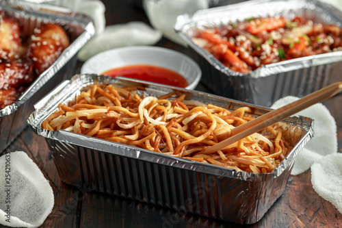 Chinese takeaway food. egg noodles with bean sprouts, chilli dip and prawn crackers © grinchh