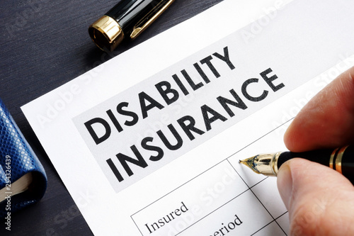 Man is filling in Disability insurance form. © designer491