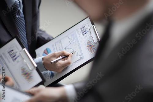 Close up of business people hands pointing growing financial business graph © yurolaitsalbert