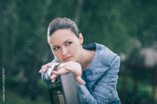 attractive young woman sitting on a Park bench © yurolaitsalbert