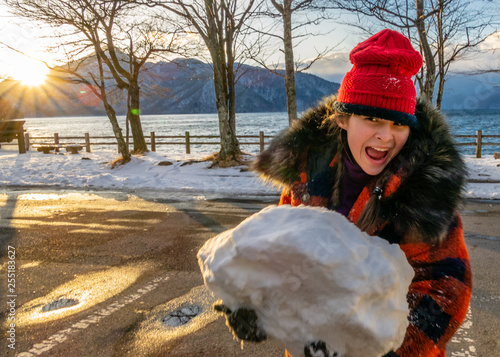 Young girl with giant snowball © imagesbykenny