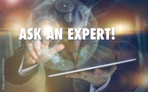 A hand selecting a Ask An Expert business concept on a futuristic computer display.