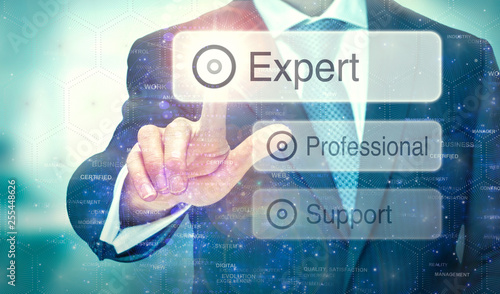 A business man selection a button on a futuristic display with a Expert concept written on it.