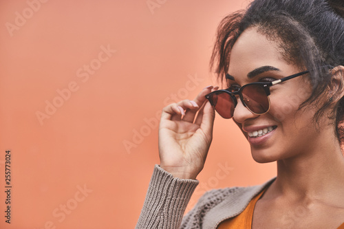 Close up of a pleasant smiling woman wearing sun glasses © Yakobchuk Olena