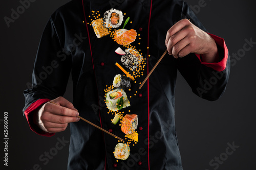 Master chef holding chopsticks with flying sushi © Jag_cz