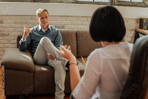 Expressive short-haired man asking for advice while having appointment