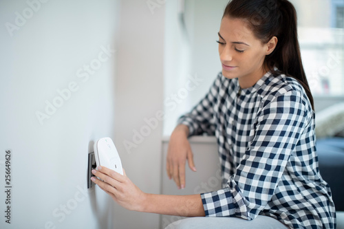 Woman Putting Smart Plug Into Power Socket At Home © Daisy Daisy