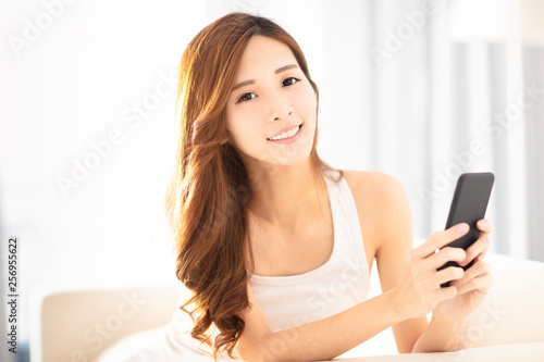 beautiful young woman using smart phone on sofa © Tom Wang
