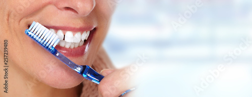 Woman teeth with toothbrush. © Kurhan