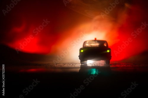 Police cars at night. Police car chasing a car at night with fog background. 911 Emergency response