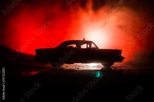 Police cars at night. Police car chasing a car at night with fog background. 911 Emergency response