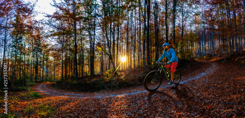 Mountain biker riding on bike in spring mountains forest landscape. Man cycling MTB enduro flow trail track. Outdoor sport activity. © Gorilla