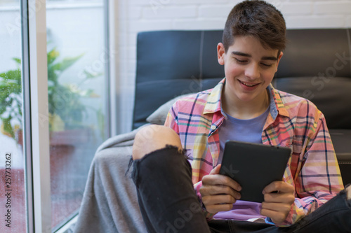 young teenager at home with digital tablet or laptop © carballo