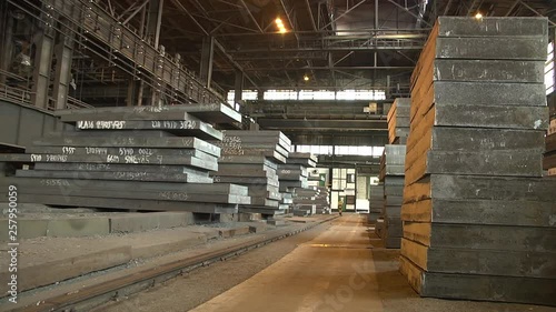 Warehouse plate shop at a metallurgical plant. A batch of thick sheets of metal. © Kate