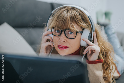 adult woman with headphones and laptop © carballo