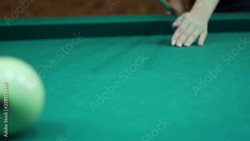 Hand aiming and hits the ball of russian billiards. © llhedgehogll