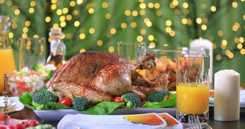 Celebrating Thanksgiving Day with roasted turkey for dinner. Roasted turkey garnished with vegetables on festive table closeup. Dolly shot 4k © manaemedia