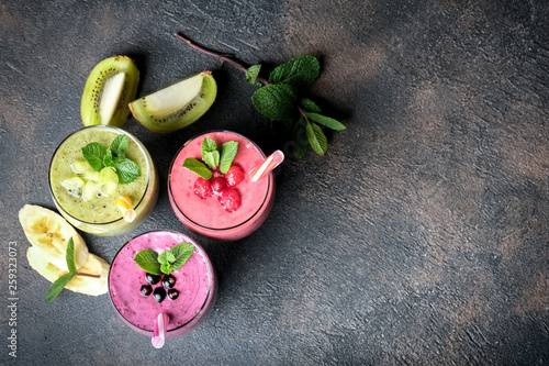 Fruit and berry smoothie blend at home against a dark background top view copy space. © Alexandr