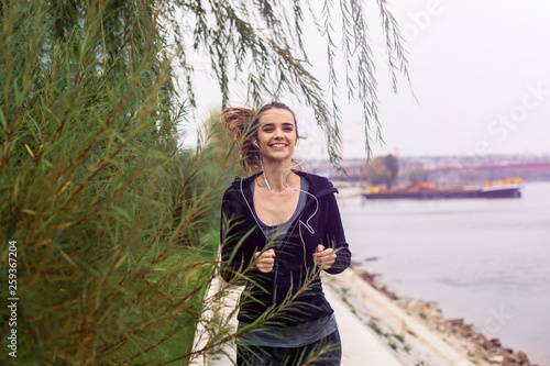 Young woman running outdoor by river © Boggy