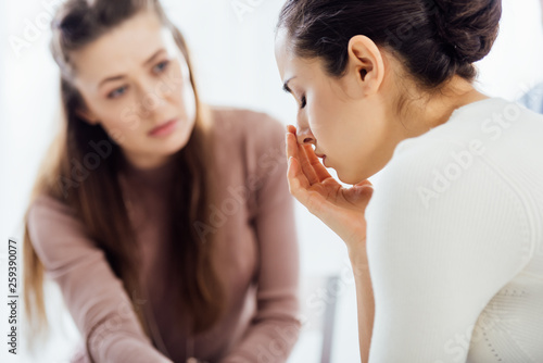 selective focus of woman crying during therapy session © LIGHTFIELD STUDIOS