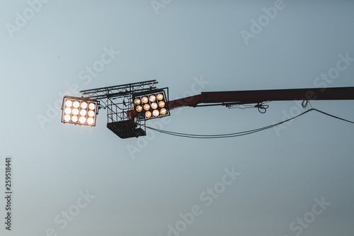 high powered spotlights illuminating an outdoor movie set © Microscope