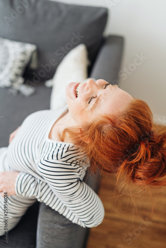 Happy young woman giggling to herself © contrastwerkstatt