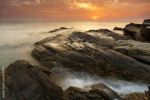 Beautiful natural seascape wave hit the rock during sunset © Thapanon Phoonchai