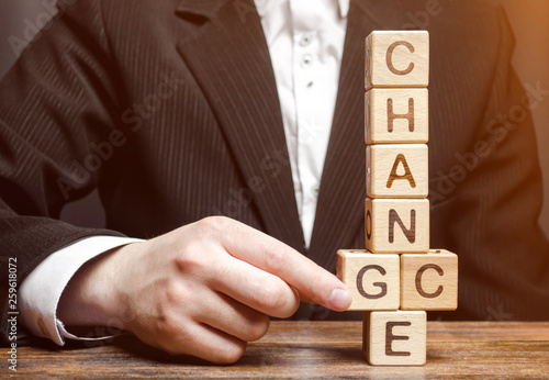 Businessman points to wooden blocks with the word Change to Chance. Personal development. Career growth or change yourself concept. Motivation, goal achievement, potential, incentive, overcoming