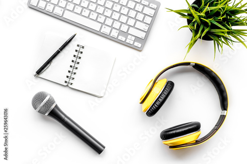 microphone, headphones, notebook and keyboard for blogger, journalist or musician work on white background top view copyspace © 9dreamstudio