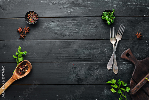 Cooking banner. Kitchen board, spices and cutlery. Top view. Free space for your text. Rustic style. © Yaruniv-Studio