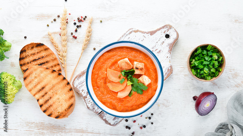 Carrot puree soup. with toast bread. Dietary food. Top view. Free copy space. © Yaruniv-Studio