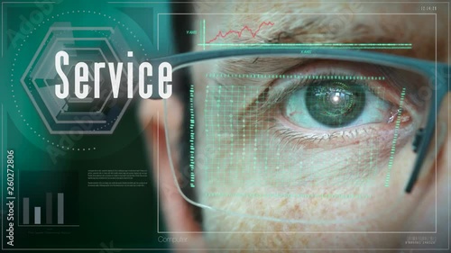 A close up of a businessman eye controlling a futuristic computer system with a Service Business concept. © duncanandison