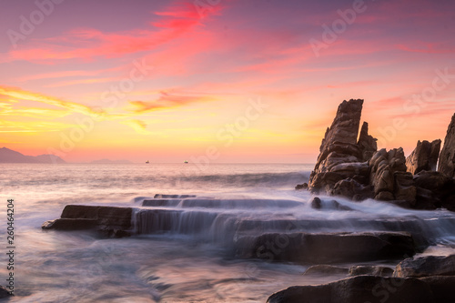 beautiful sunset at rocky beach © jon_chica